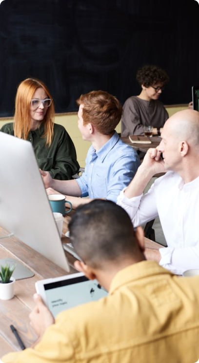 Group of colleagues working together at a shared workspace